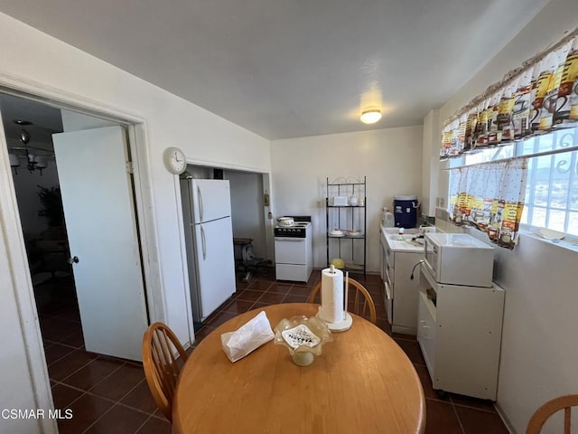 dining area with dark tile patterned floors