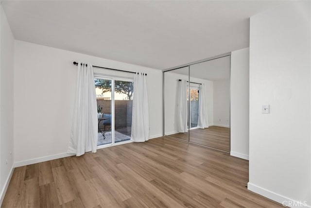 spare room with light hardwood / wood-style flooring