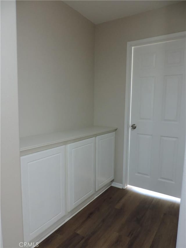 empty room with dark hardwood / wood-style flooring