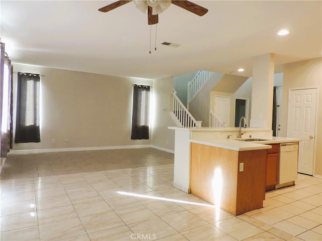 kitchen with ceiling fan, sink, white dishwasher, a center island with sink, and light tile patterned floors