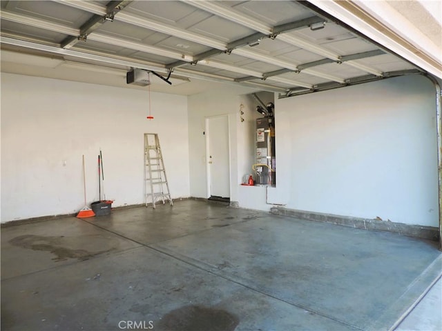 garage featuring water heater and a garage door opener