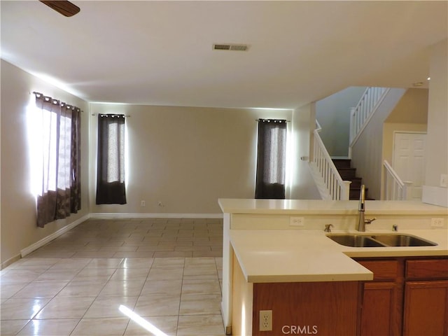 kitchen featuring light tile patterned floors and sink