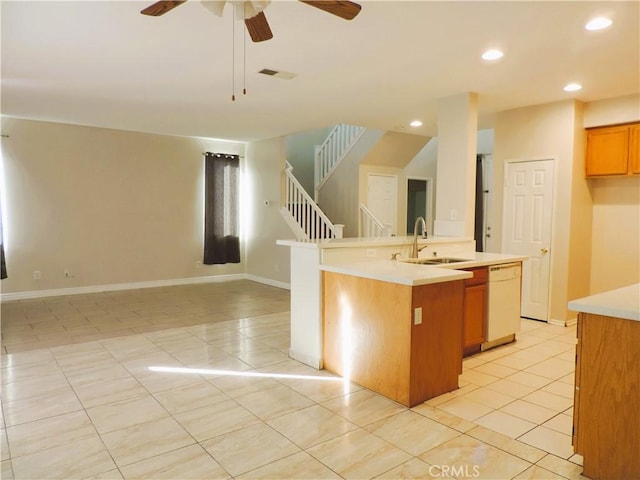 kitchen featuring dishwasher, a center island with sink, sink, ceiling fan, and light tile patterned floors