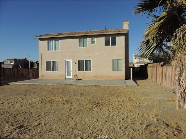 rear view of property featuring a patio