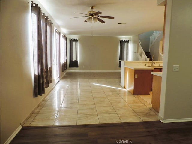 hall with sink and light tile patterned floors