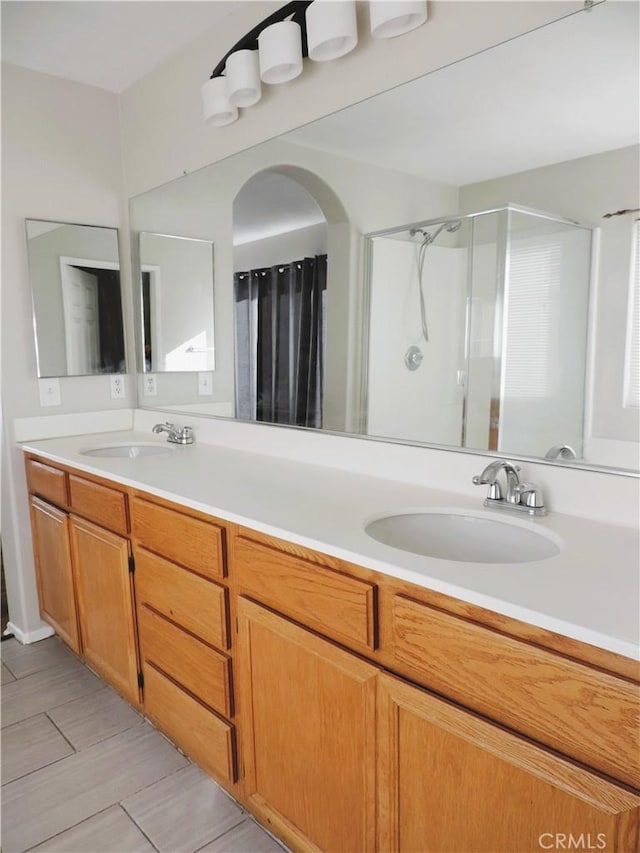 bathroom featuring vanity and an enclosed shower