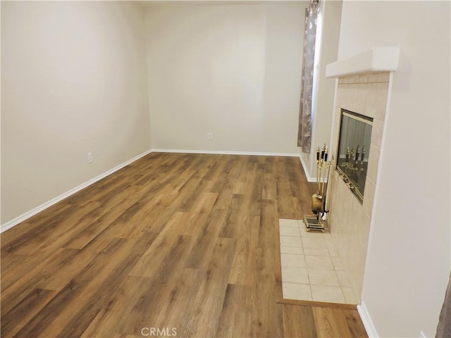 unfurnished living room featuring a fireplace and hardwood / wood-style floors