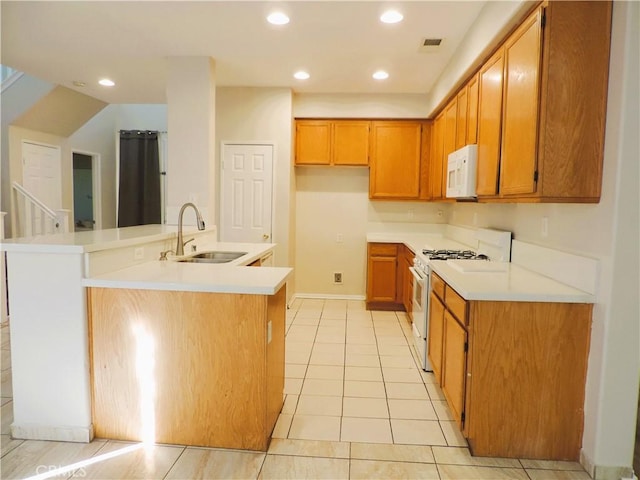 kitchen featuring kitchen peninsula, white appliances, light tile patterned flooring, and sink