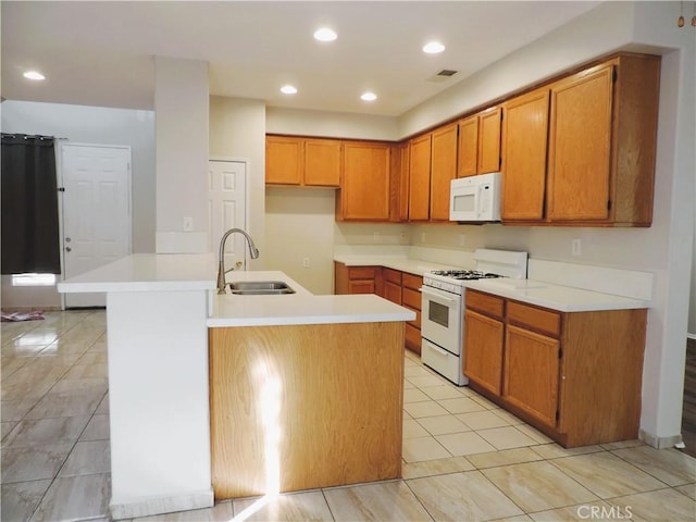 kitchen featuring light tile patterned flooring, white appliances, and sink