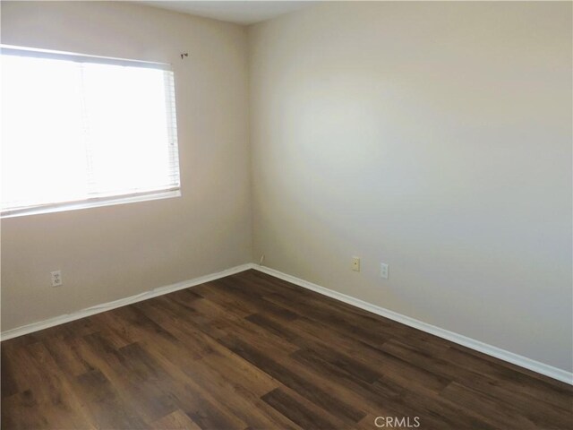 spare room featuring dark hardwood / wood-style flooring