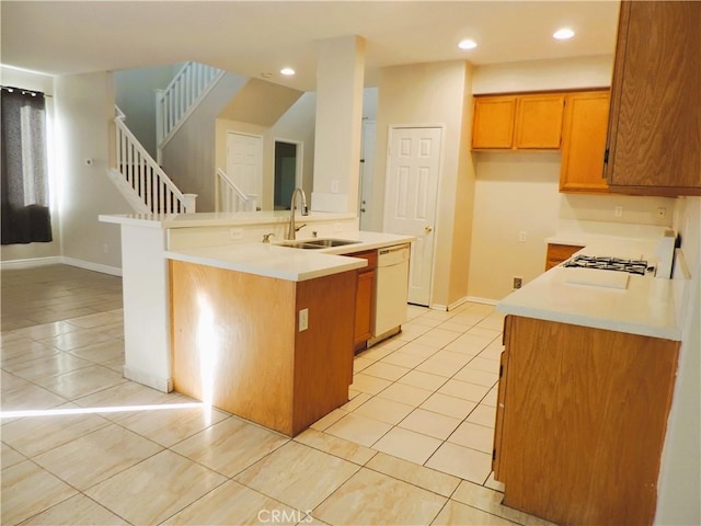 kitchen with dishwasher, a center island with sink, light tile patterned flooring, and sink