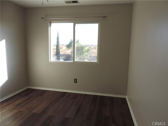 spare room with dark wood-type flooring