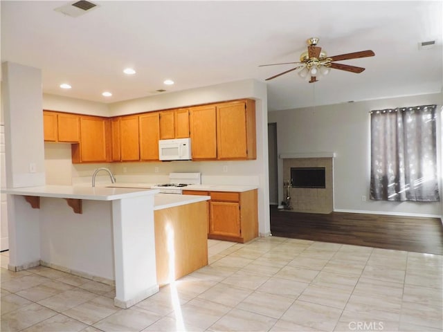 kitchen featuring ceiling fan and stove