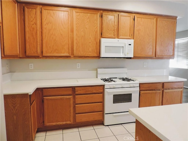 kitchen featuring white appliances and light tile patterned floors