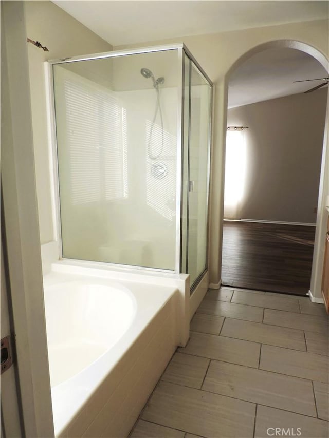 bathroom featuring vanity and independent shower and bath