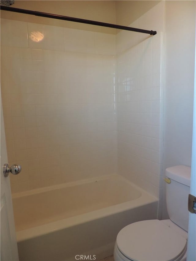 bathroom featuring bathing tub / shower combination and toilet