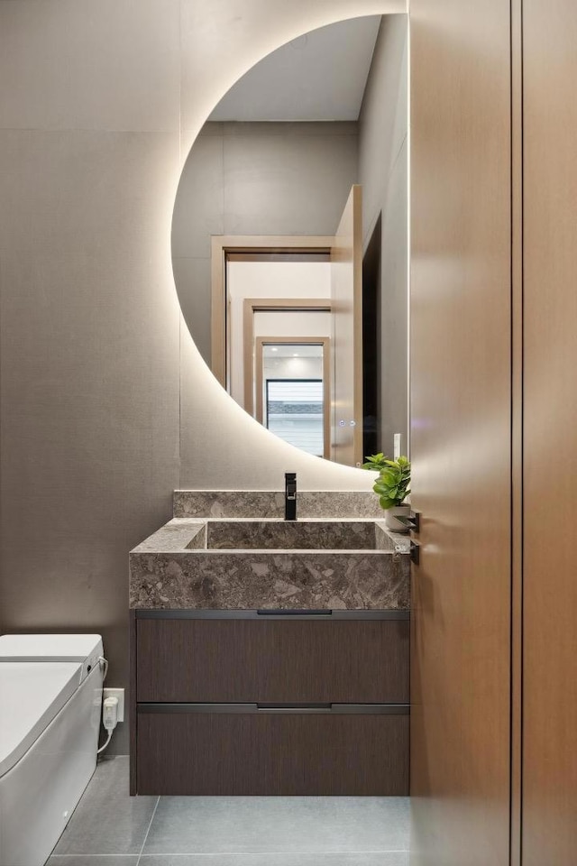 bathroom with tile patterned flooring, vanity, and toilet