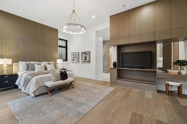 bedroom featuring a chandelier and light wood-type flooring