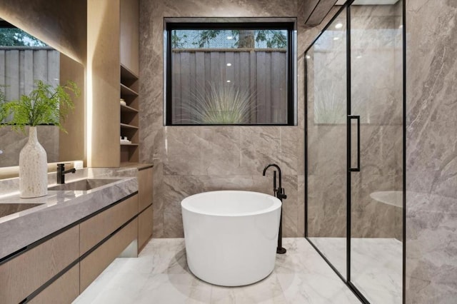 bathroom with vanity, tile walls, and independent shower and bath