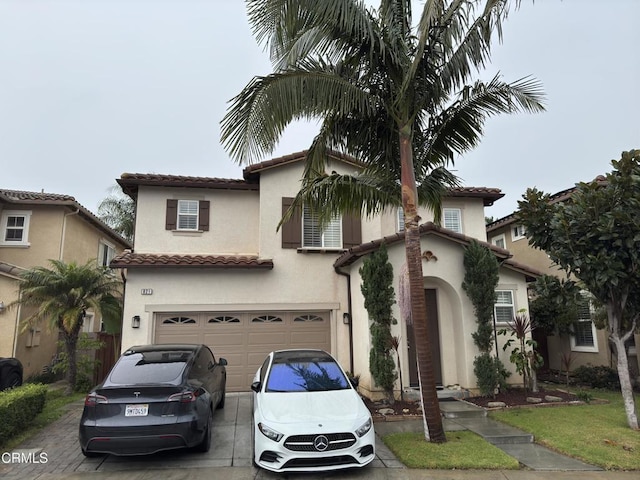 mediterranean / spanish-style home with a garage