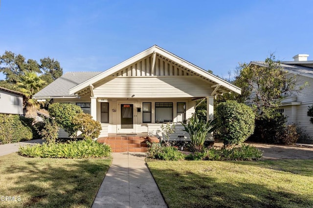 bungalow-style house featuring a front lawn and a porch