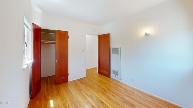 unfurnished bedroom featuring a closet and light hardwood / wood-style flooring