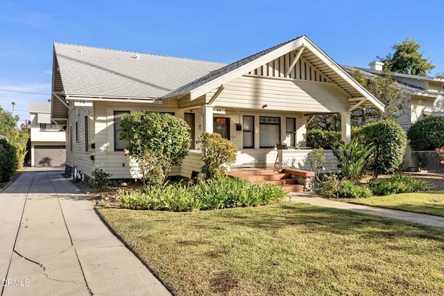 view of front of property with a porch and a front lawn