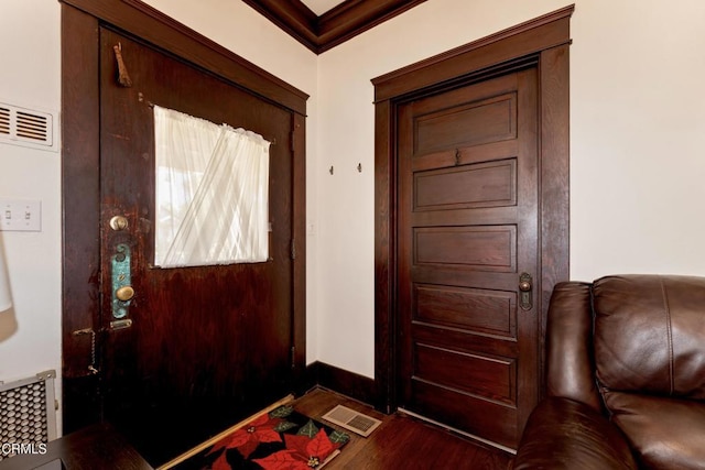 foyer with wood-type flooring and ornamental molding