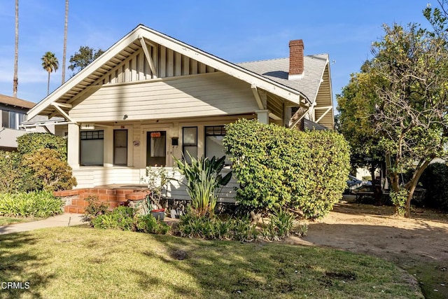 bungalow-style home with a front lawn