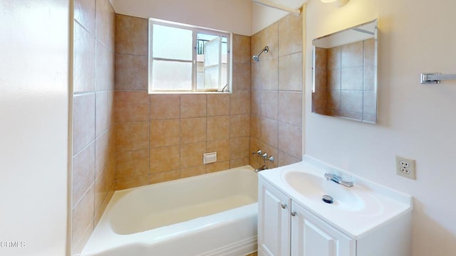 bathroom featuring vanity and tiled shower / bath