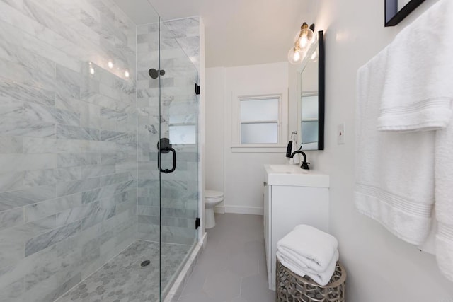 bathroom with tile patterned floors, vanity, toilet, and a shower with shower door