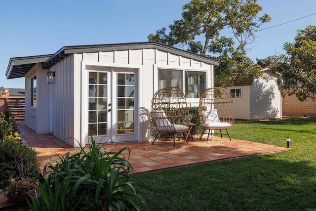 view of outbuilding with a lawn and french doors