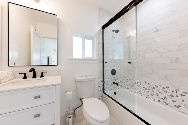 full bathroom featuring vanity, toilet, and combined bath / shower with glass door