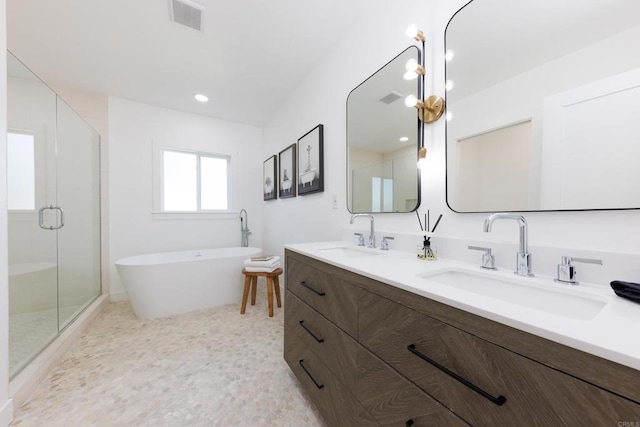 bathroom featuring plus walk in shower and vanity