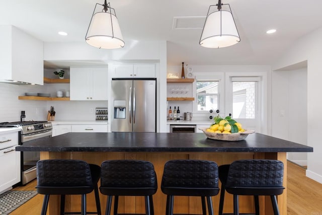 kitchen featuring white cabinets, stainless steel appliances, and a kitchen island