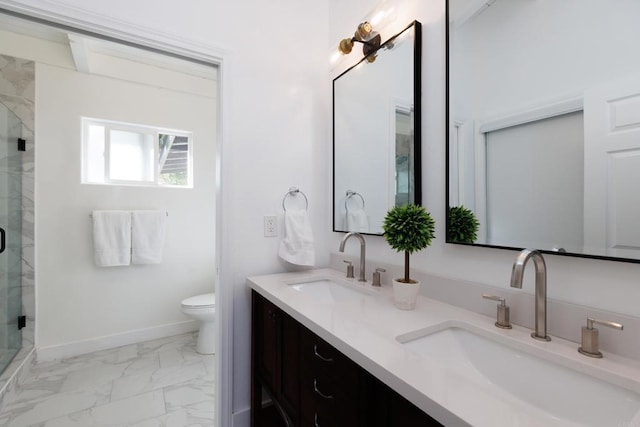 bathroom with a shower with door, vanity, and toilet