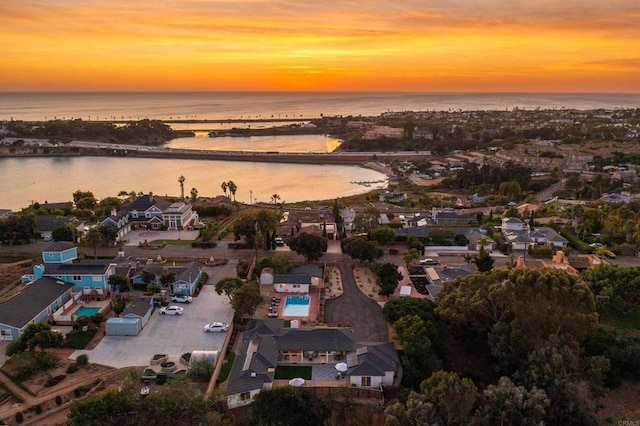 aerial view at dusk with a water view