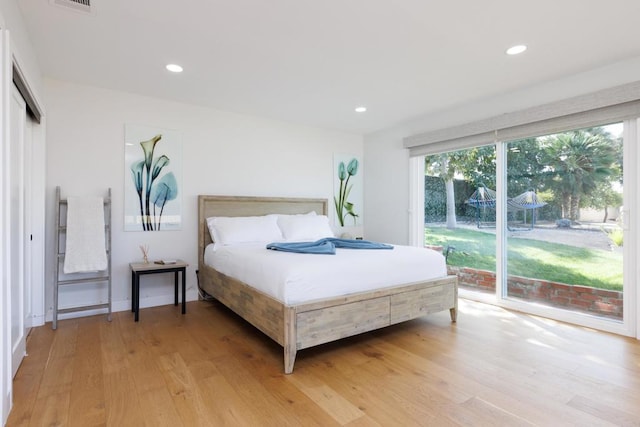 bedroom featuring access to outside and light hardwood / wood-style flooring