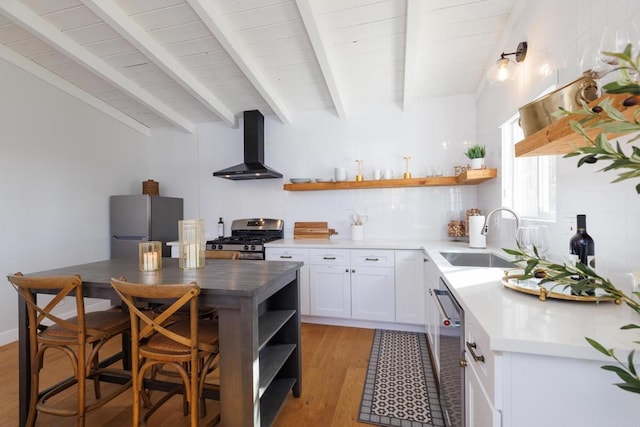 kitchen featuring white cabinetry, sink, wall chimney exhaust hood, stainless steel appliances, and light hardwood / wood-style flooring