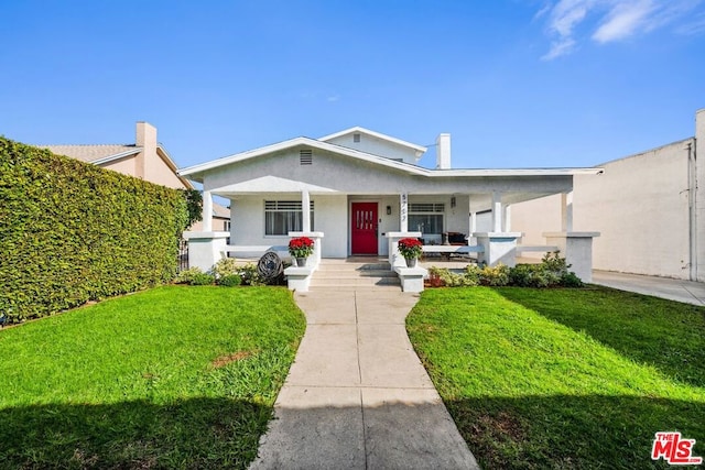 view of front of property with covered porch and a front lawn