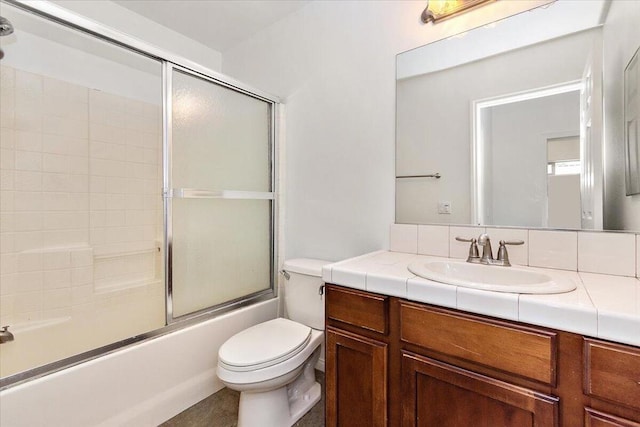 full bathroom with vanity, toilet, and bath / shower combo with glass door