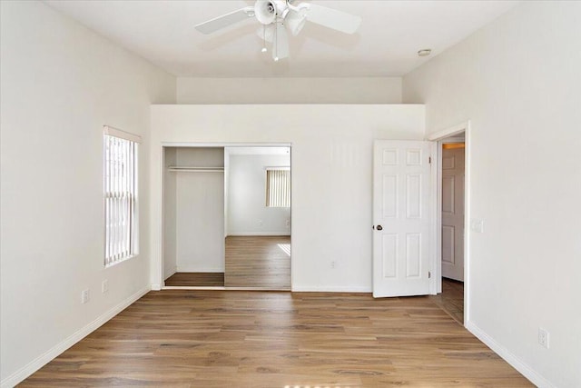 unfurnished bedroom with hardwood / wood-style floors, ceiling fan, and a closet