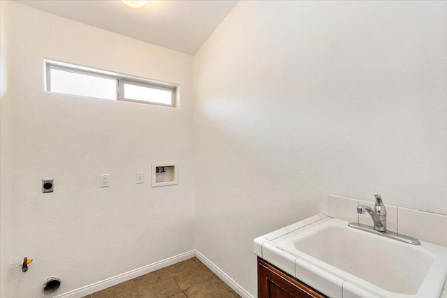 laundry area featuring tile patterned floors, hookup for a gas dryer, sink, washer hookup, and hookup for an electric dryer