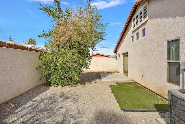 view of yard featuring a patio and central AC unit