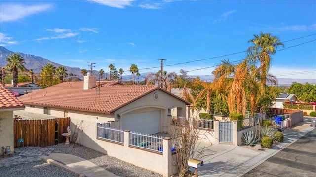 view of front of house with a mountain view and a garage