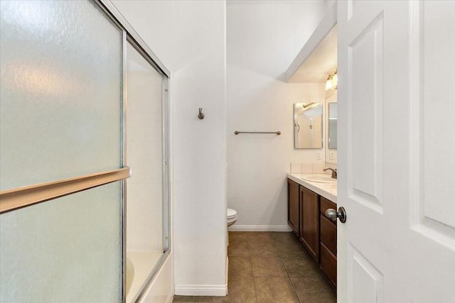 full bathroom with tile patterned flooring, vanity, toilet, and combined bath / shower with glass door