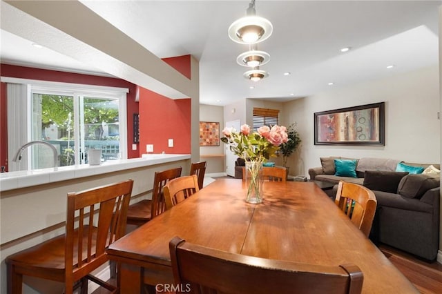 dining room featuring wood-type flooring and sink