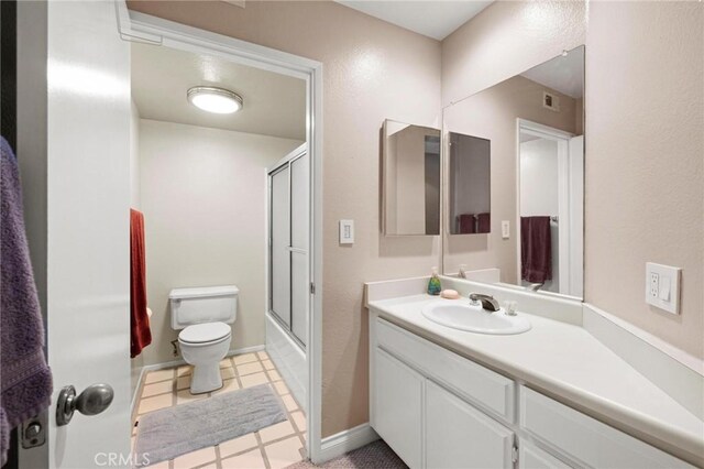 full bathroom with tile patterned floors, toilet, vanity, and combined bath / shower with glass door