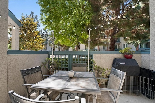 view of patio / terrace with a grill and a balcony