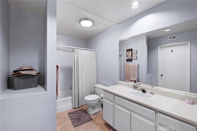 full bathroom featuring tile patterned floors, vanity, toilet, and shower / bath combo with shower curtain